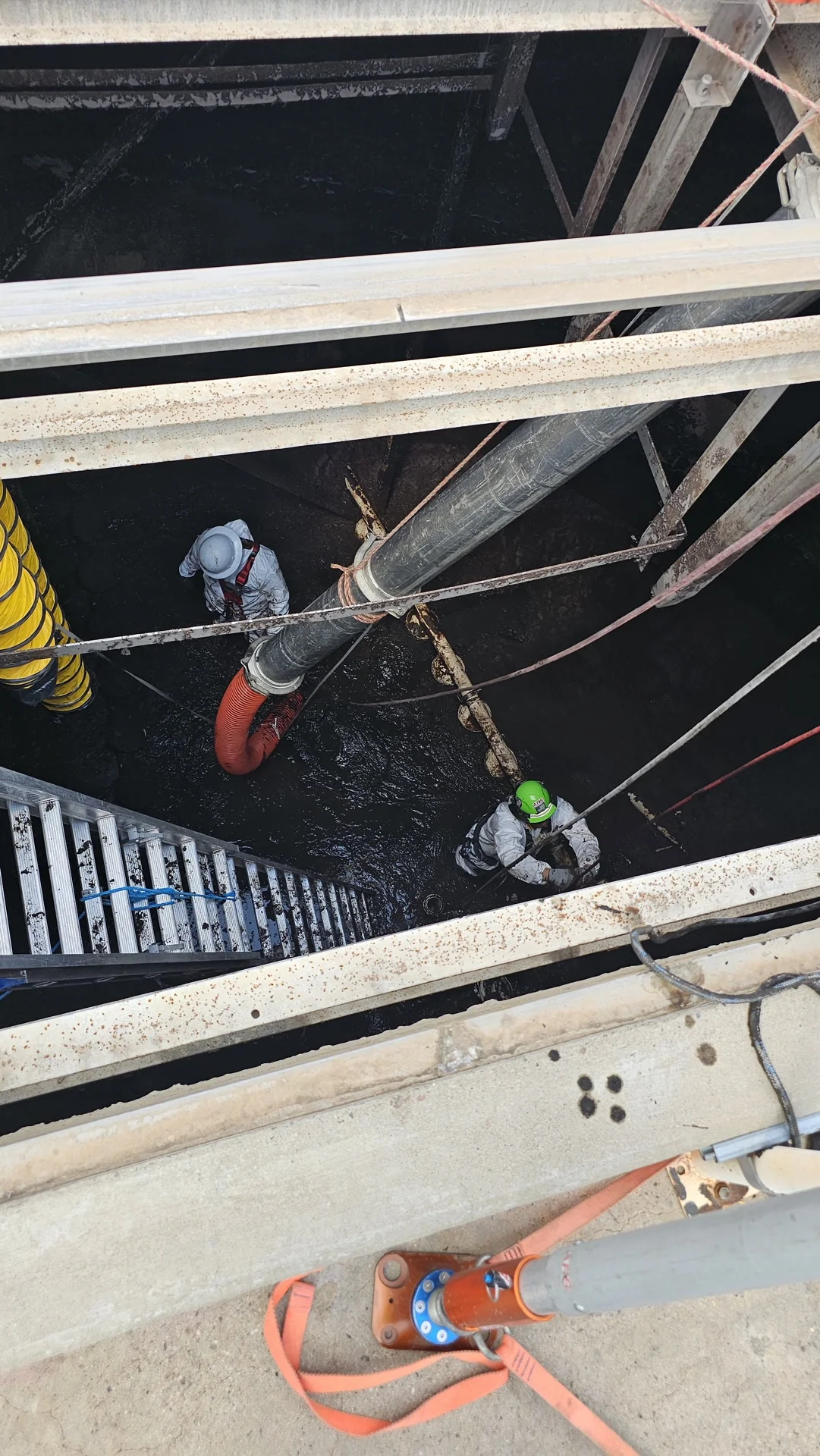 Worker in Tyvek suit preparing for confined space entry