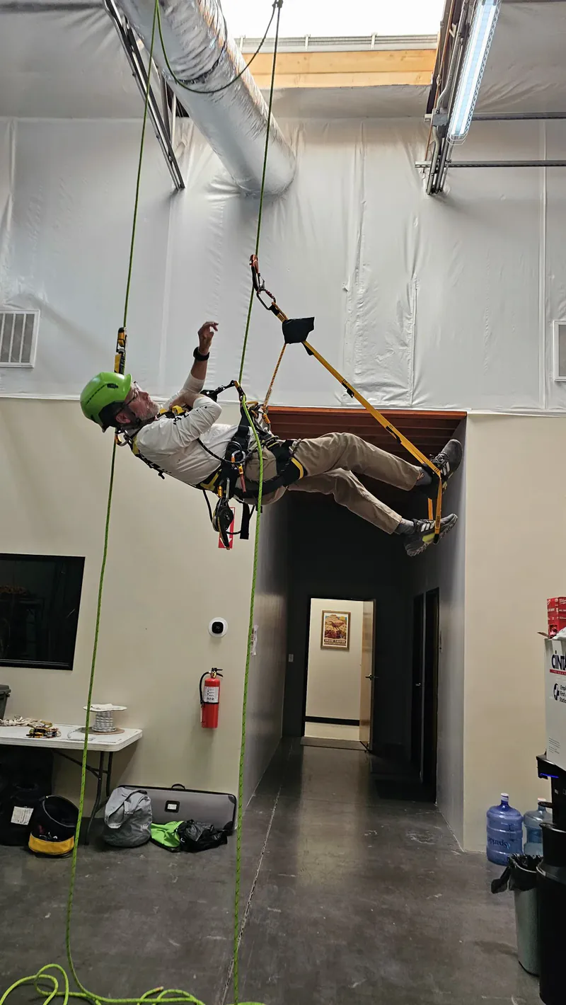 A rope access student suspended on ropes inside the Phoenix Safety Training Center